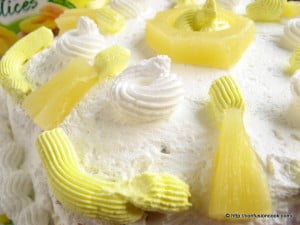 A whole eggless pineapple gateau with layers of pineapple filling and whipped cream