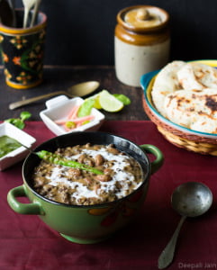 A bowl of creamy Dal Makhani garnished with butter and fresh cilantro