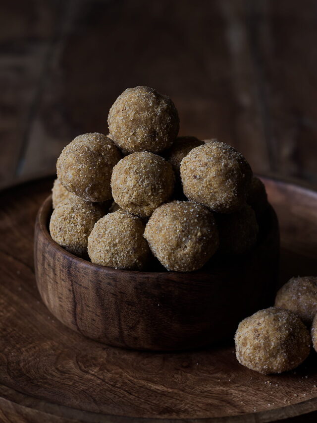 Freshly prepared laddus cooling on a plate