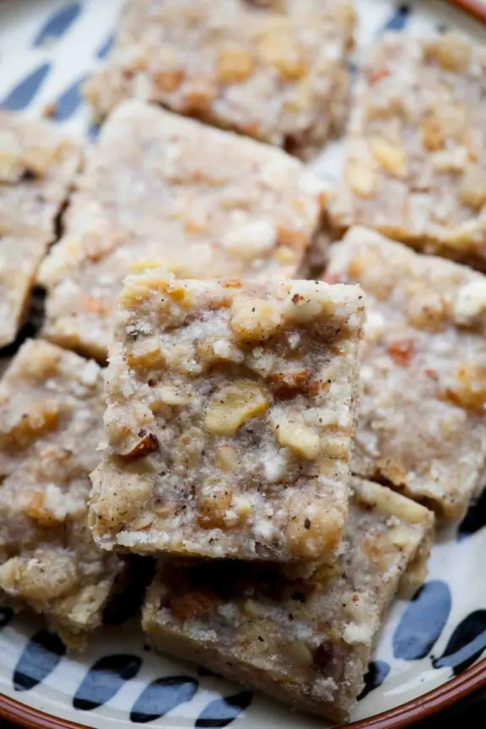 Gond panjiri served in a steel plate with almonds and cashews