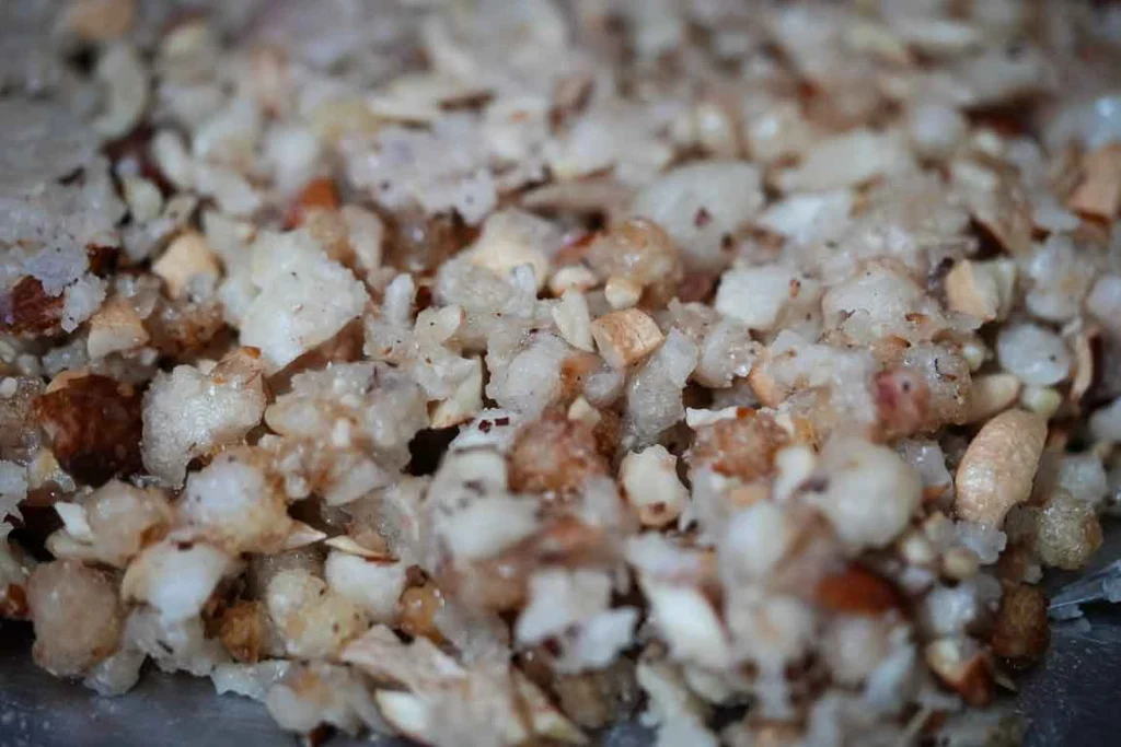 Golden roasted gond pieces cooling on a plate