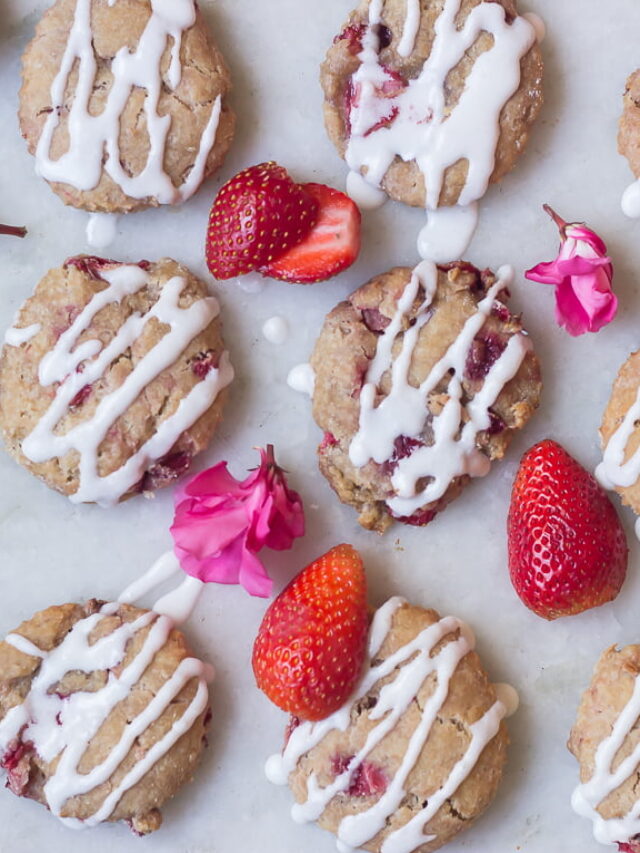 A close-up of a baked scone showing chunks of strawberries inside