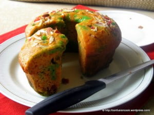 Freshly baked eggless tutti frutti cake loaf on a wooden board