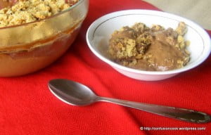 Layered eggless mocha custard in a bowl, with crushed cookies on top