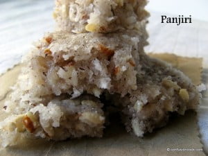 A bowl of Panjiri, filled with a mix of nuts, seeds, and roasted wheat flour, garnished with dried fruits