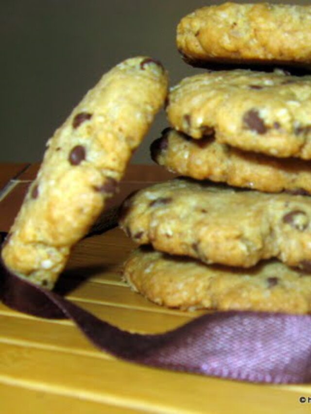 Freshly baked oatmeal chocolate chip cookies stacked on a plate