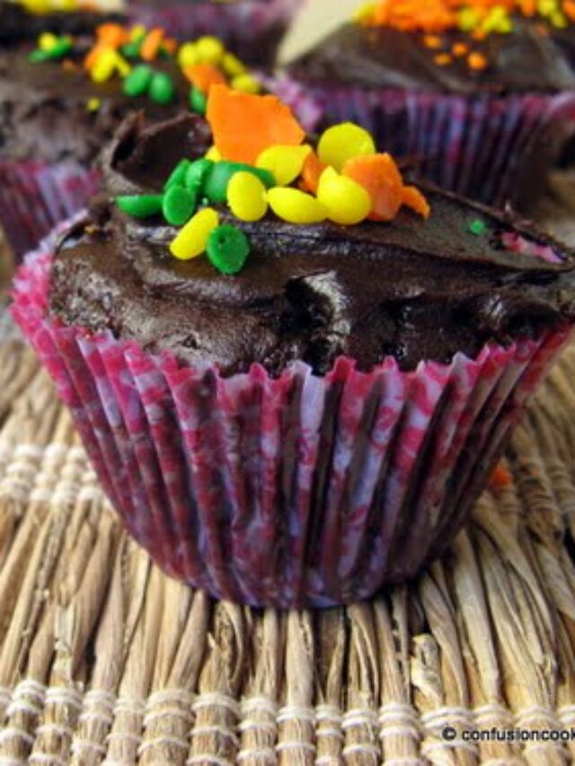 Close-up of a chocolate cupcake topped with colorful sprinkles