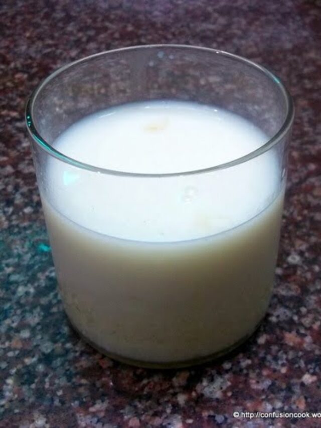 Homemade Thandai poured into glasses topped with chopped dry fruits
