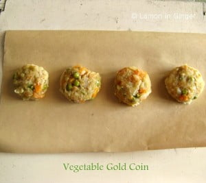 Golden-brown Veg Gold Coins arranged on a platter with garnished cheese