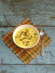 Close-up of a bowl filled with creamy Kesar Shrikhand garnished with saffron strands