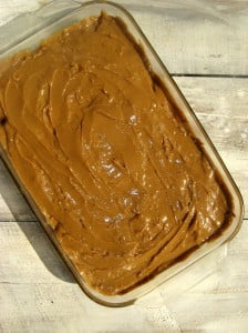 A freshly baked Banana Tres Leches Cake topped with whipped cream and caramel drizzle