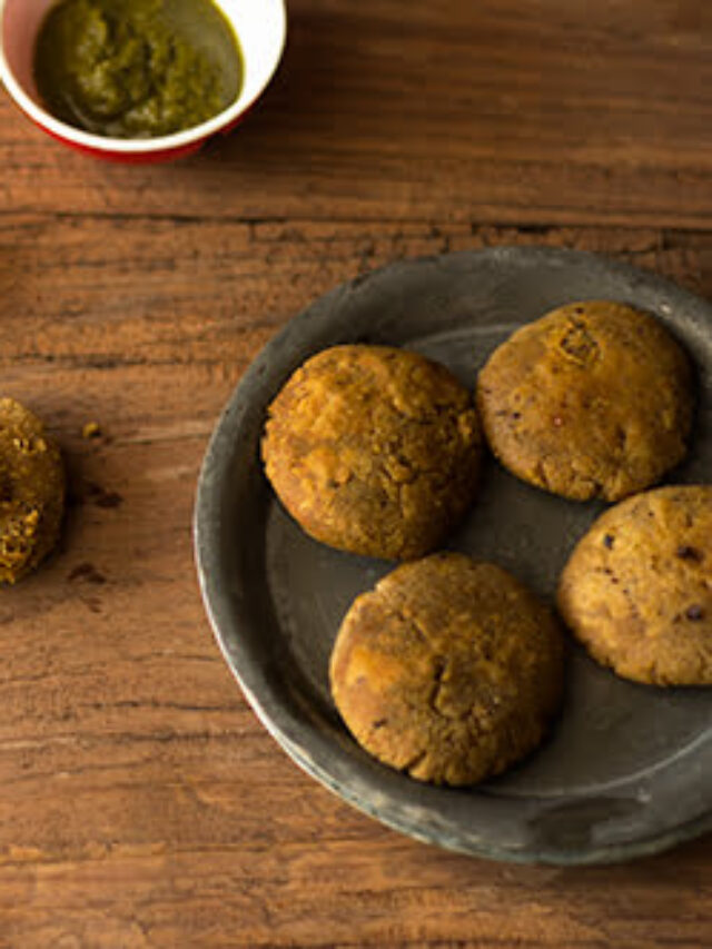 Golden-brown Chana Dal ke Kebab served on a white plate with mint chutney