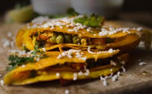 Moong dal chilla garnished with a sprinkle of cumin seeds and fresh coriander