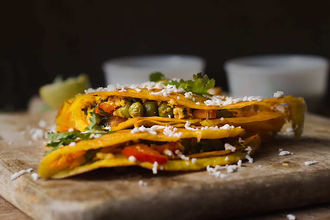 Close-up of a crispy moong dal chilla with a sprinkle of chopped coriander
