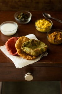 Close up view of palak and beetroot puris
