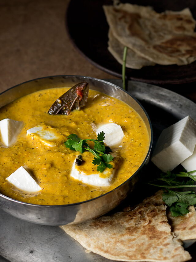 Close-up of Kadai Paneer garnished with fresh coriander and ginger juliennes