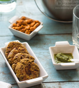 Finished kebabs garnished with fresh herbs and served with chutney