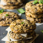 Freshly baked basil chocolate chunky cookies arranged on a cooling rack, showcasing their rich texture