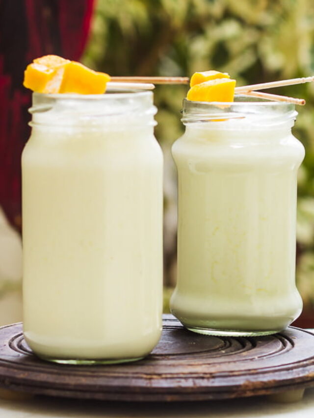 A refreshing glass of sweet lassi with a garnish of mangoes