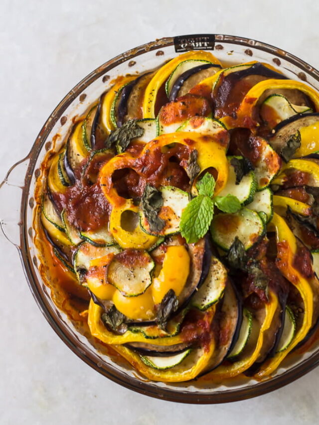 A vibrant dish of Baked Ratatouille with colorful layers of sliced vegetables