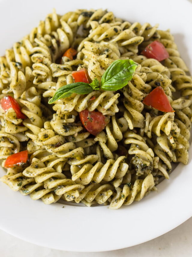 Close-up of creamy Sicilian pesto pasta with basil garnish