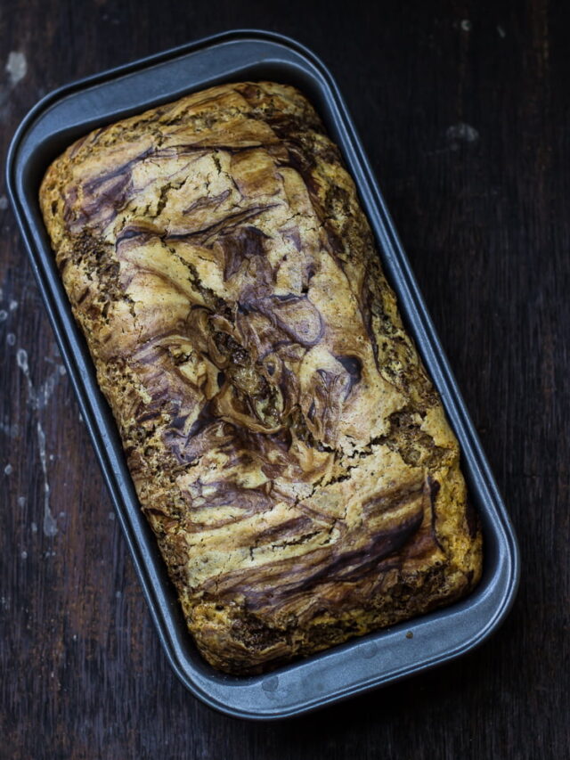 Top view of the Eggless Chocolate Vanilla Swirl Cake with a rich, glossy chocolate glaze