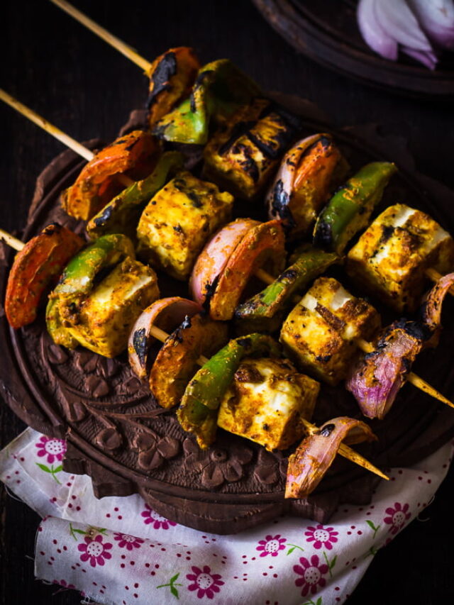 Restaurant-style Tandoori Paneer Tikka served on a platter with fresh mint chutney