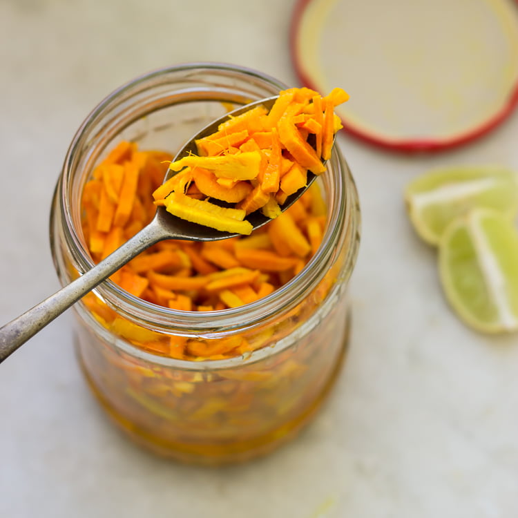 A spoonful of Raw Turmeric Pickle, highlighting the rich texture and bright color