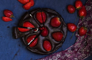 Overhead view of chocolate strawberry tart with a glossy chocolate ganache layer