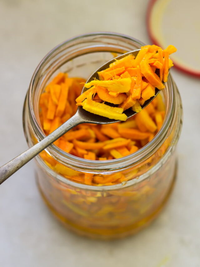 A spoonful of Raw Turmeric Pickle, highlighting the rich texture and bright color