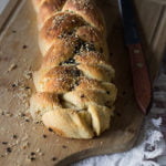 A single slice of challah bread topped with sesame seeds