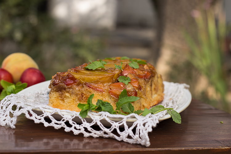 Close-up of the vibrant fruit topping on a peach and plum upside-down cake