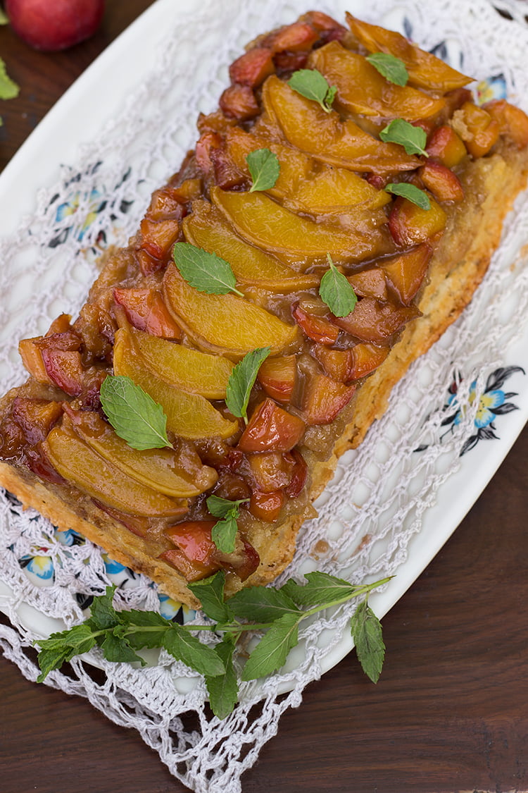 Peach and plum upside-down cake being served on a tray