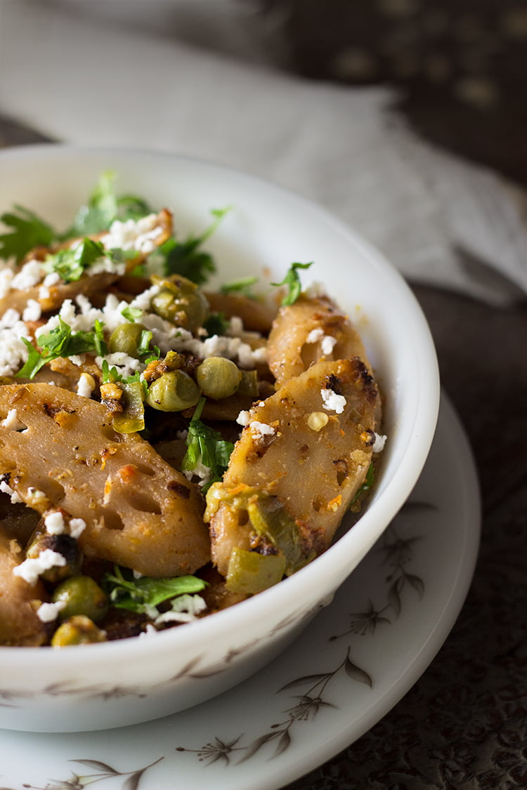 A bowl of Kamal Kakdi Ki Sabji garnished with grated paneer