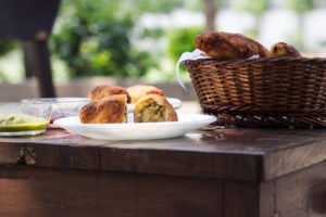 Golden brown potato stuffed bread rolls served on a plate