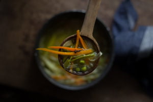 Close-up of hot Indian veg soup with colorful chopped vegetables