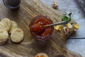 Lemon Chilli Pickle has been served with the snacks on a wooden tray