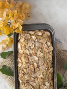 Close-up of a moist and fluffy eggless cardamom cinnamon cake topped with sugar