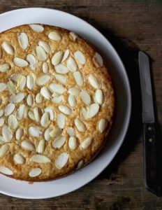 A beautifully decorated Eggless Kaju Cake topped with almonds