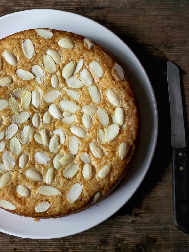 A beautifully decorated Eggless Kaju Cake topped with almonds