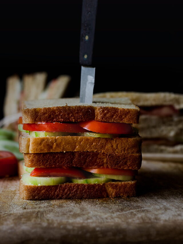 Fresh tomato cucumber sandwich served on a white plate