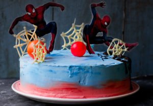 Close-up of the homemade Spiderman cake, showing the vibrant layers and intricate webbing detail