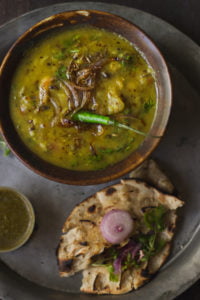 A close-up shot of a bowl filled with Panchmel Dal, showcasing the rich, creamy texture and vibrant yellow color
