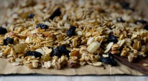Freshly baked healthy granola on a baking tray lined with parchment paper