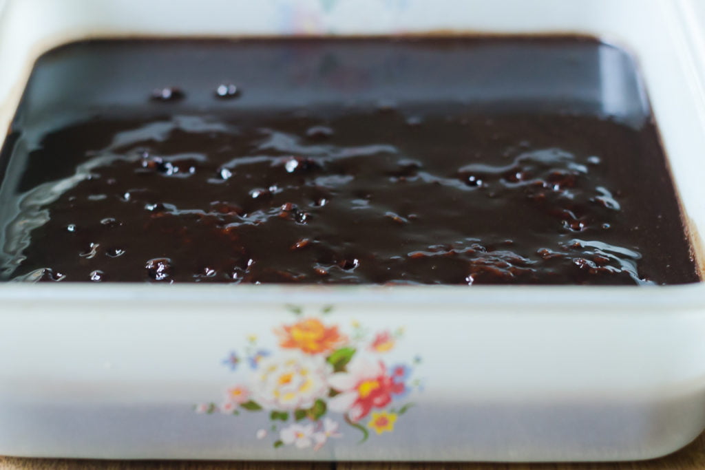 Top view of Eggless Whiskey Coffee Poke Cake with coffee and whiskey syrup glaze