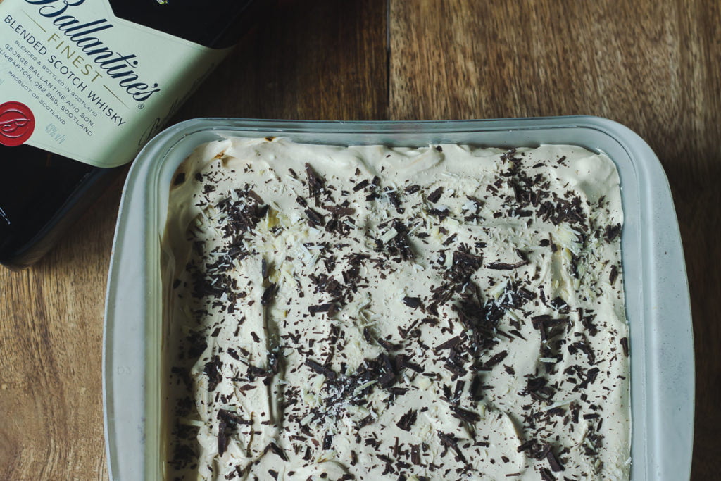 Close-up of Eggless Whiskey Coffee Poke Cake with whiskey glaze drizzled on top