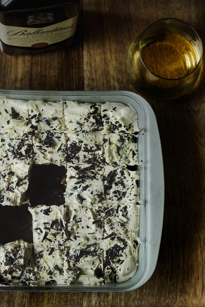 Garnishing the cake with whipped cream and chocolate shavings