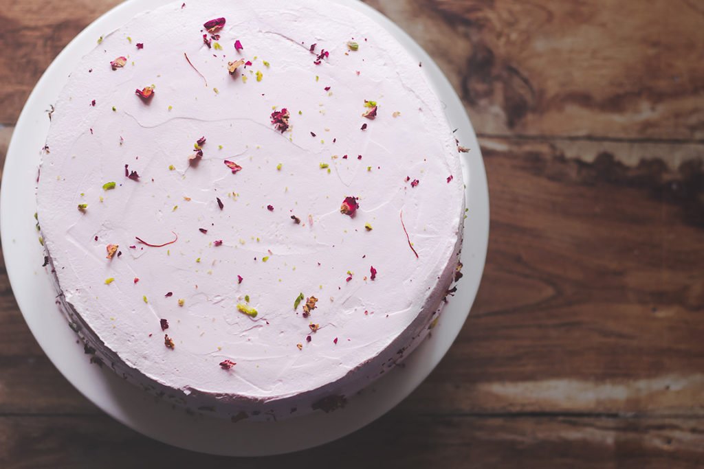 A stunning eggless cake decorated with dried rose petals