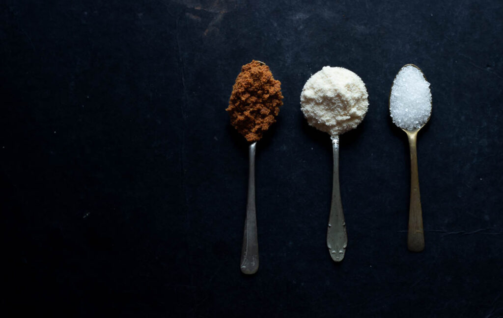 Side-by-side comparison of Desi Khand, Bura, and Cheeni in separate spoon