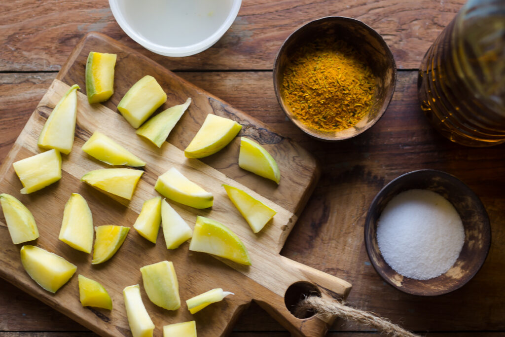 Close-up of raw mango pieces, spices and salt ready to make aam ka achar